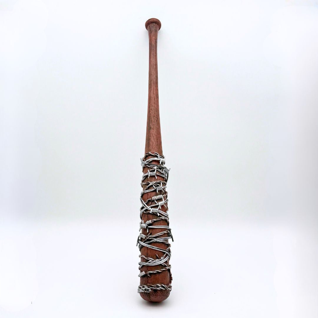 Dark woodgrain baseball bat with silver barbwire wrapped around top half leaning agains a white background