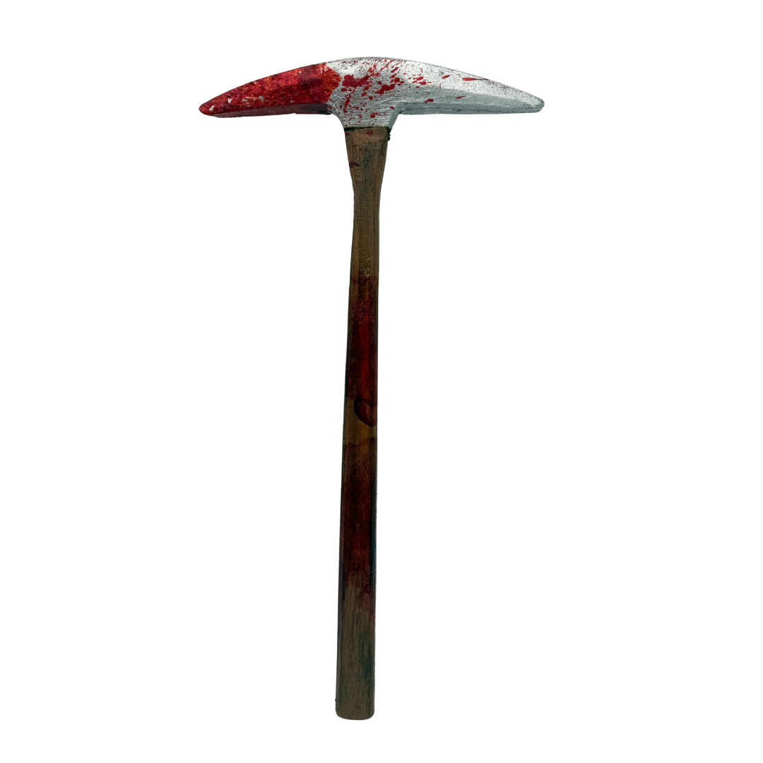 A pickhead axe with a weathered silver head splattered with red blood, and a dark brown wooden handle, isolated on a white background.
