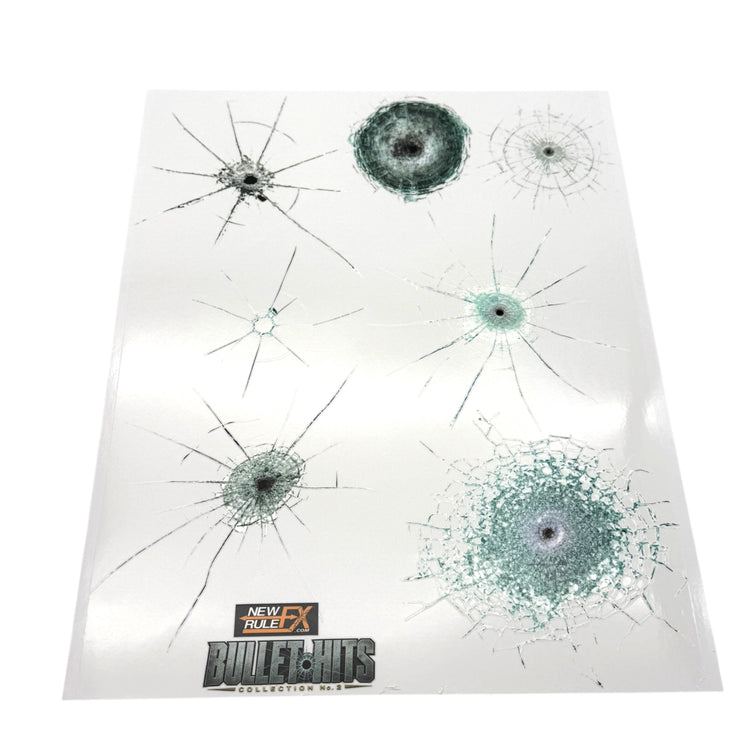 NewRuleFX Glass Hits Collection 2 sheet with seven glass bullet-impact decals in varied crack and shatter patterns.