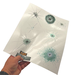 Hand holding the Glass Hits Collection 2 decal sheet with seven simulated glass bullet impacts.