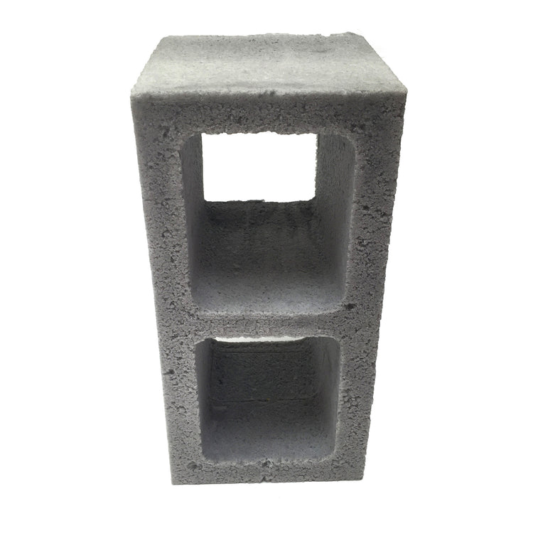 Front view of a realistic flexible foam prop cinder block with a gray stone color and texture, designed for safe use in stunts, theater, or film