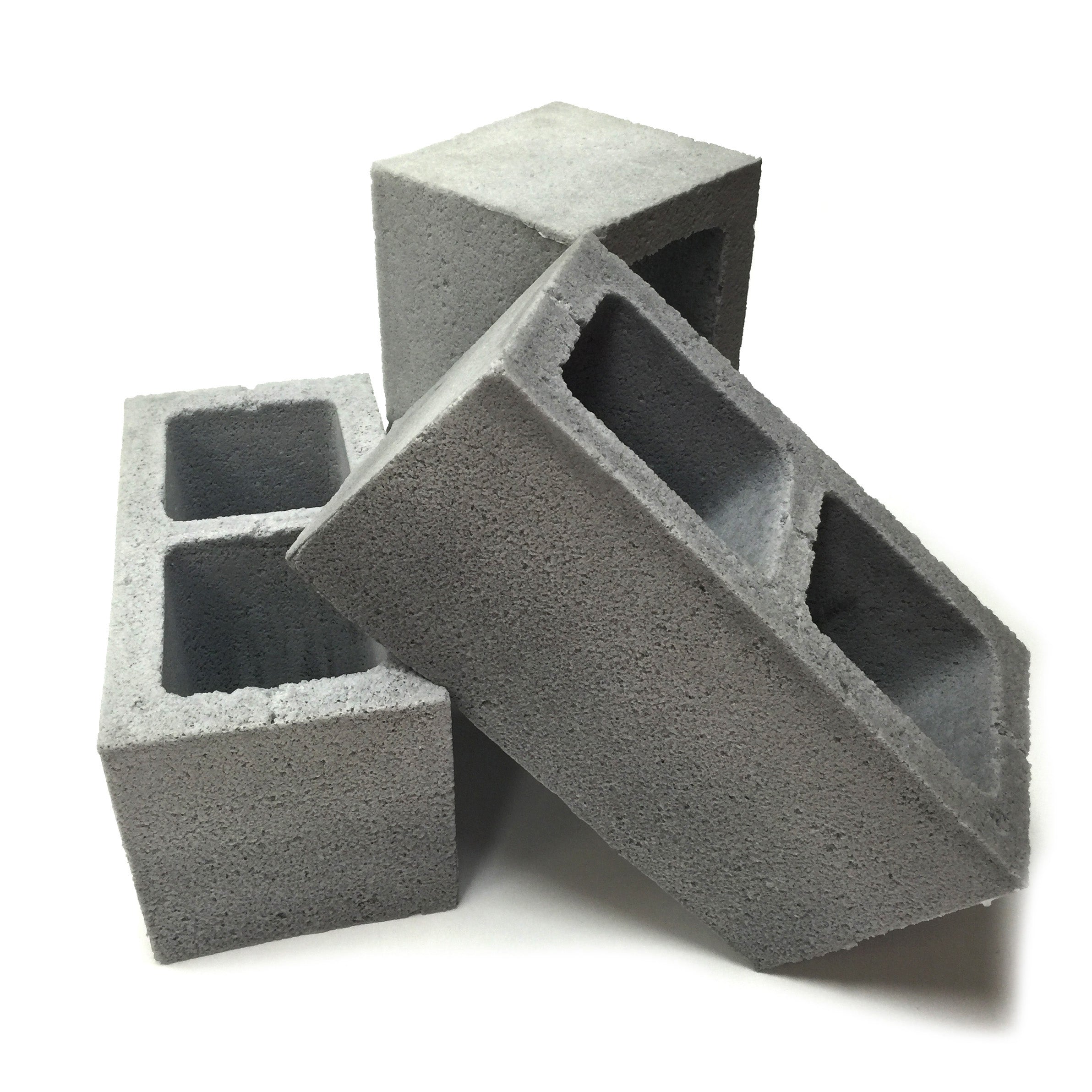 Group view of three realistic flexible foam prop cinder blocks with a gray stone color and texture, designed for safe use in stunts, theater, or film