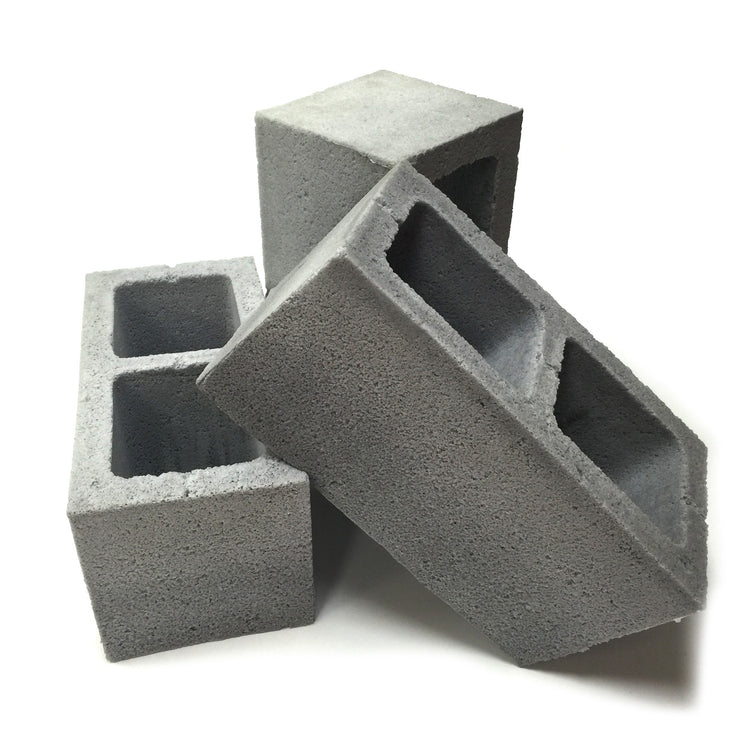 Group view of three realistic flexible foam prop cinder blocks with a gray stone color and texture, designed for safe use in stunts, theater, or film