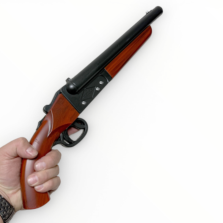 Hand holding a rifle with wooden stock and black metal parts on a white background
