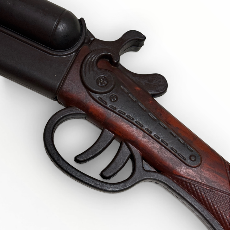 Close-up of a wooden and metal gun on a white background