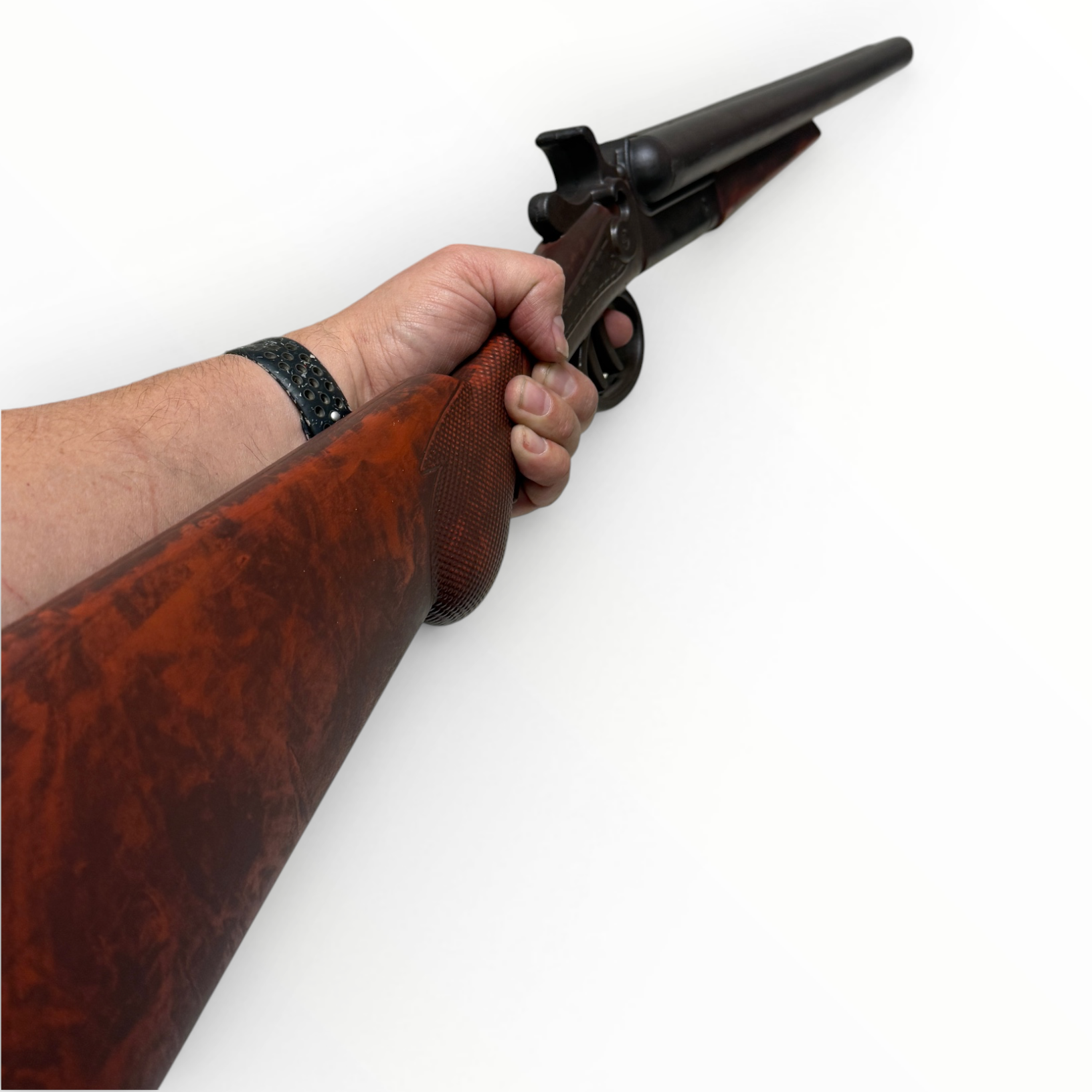 Hand holding a wooden rifle on a white background