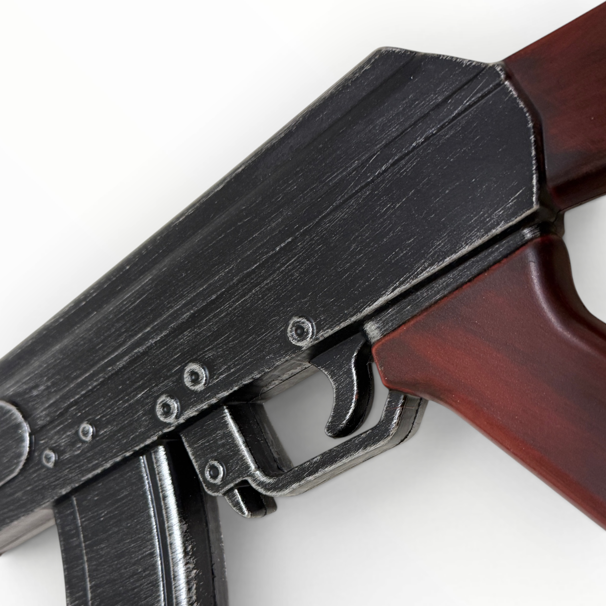 Close-up of a firearm with a wooden stock on a white background