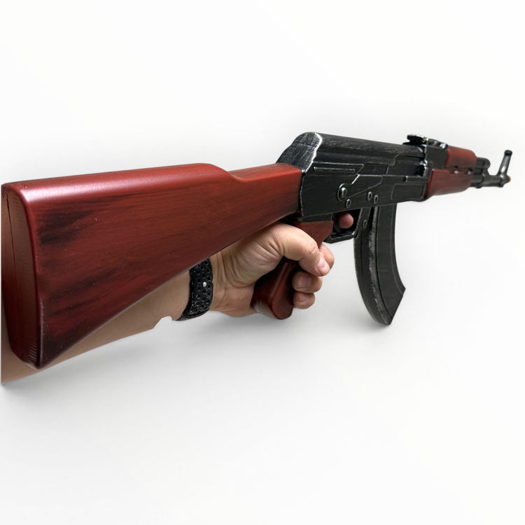 Hand holding a rifle with a wooden stock on a white background