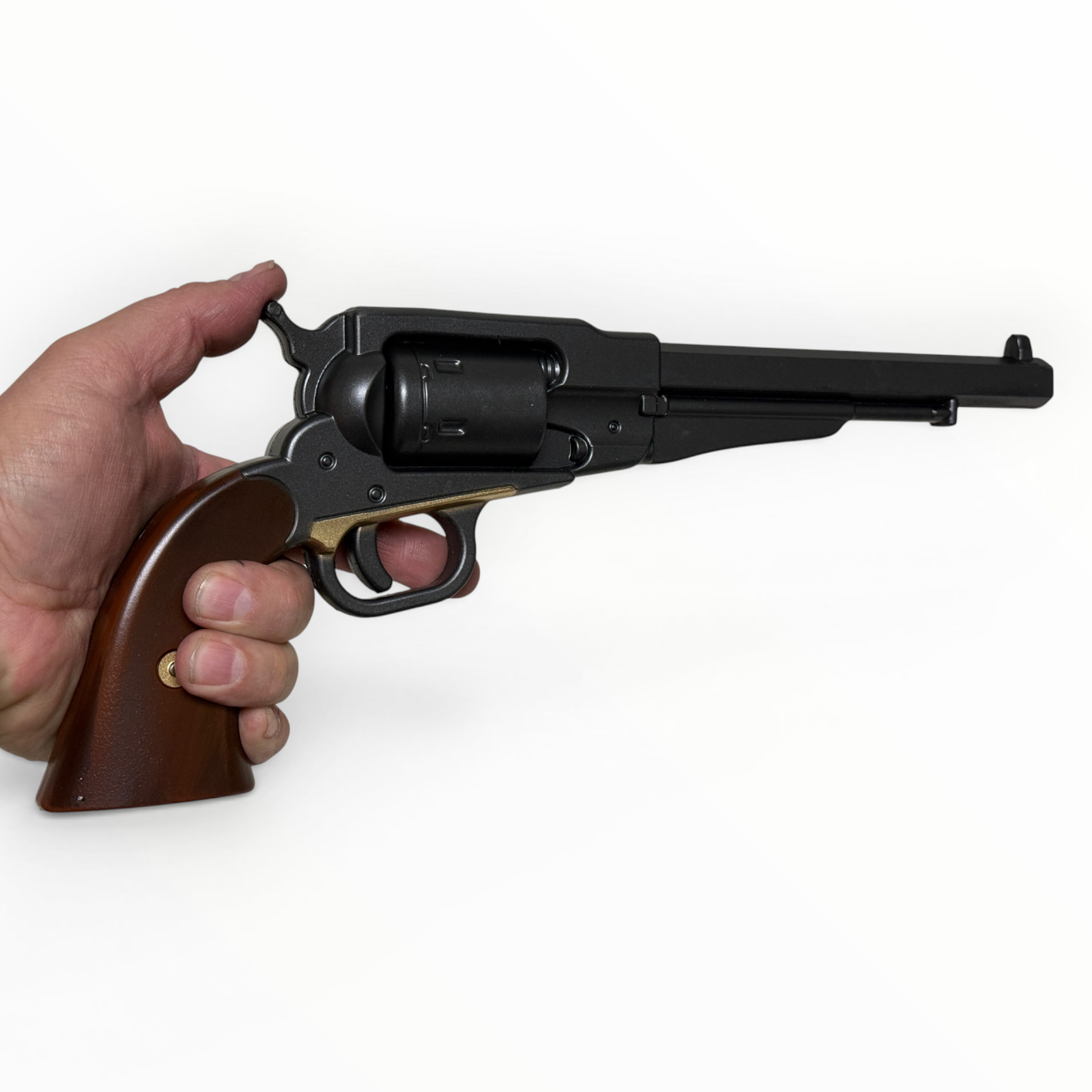Hand holding a black revolver with wooden grip on a white background