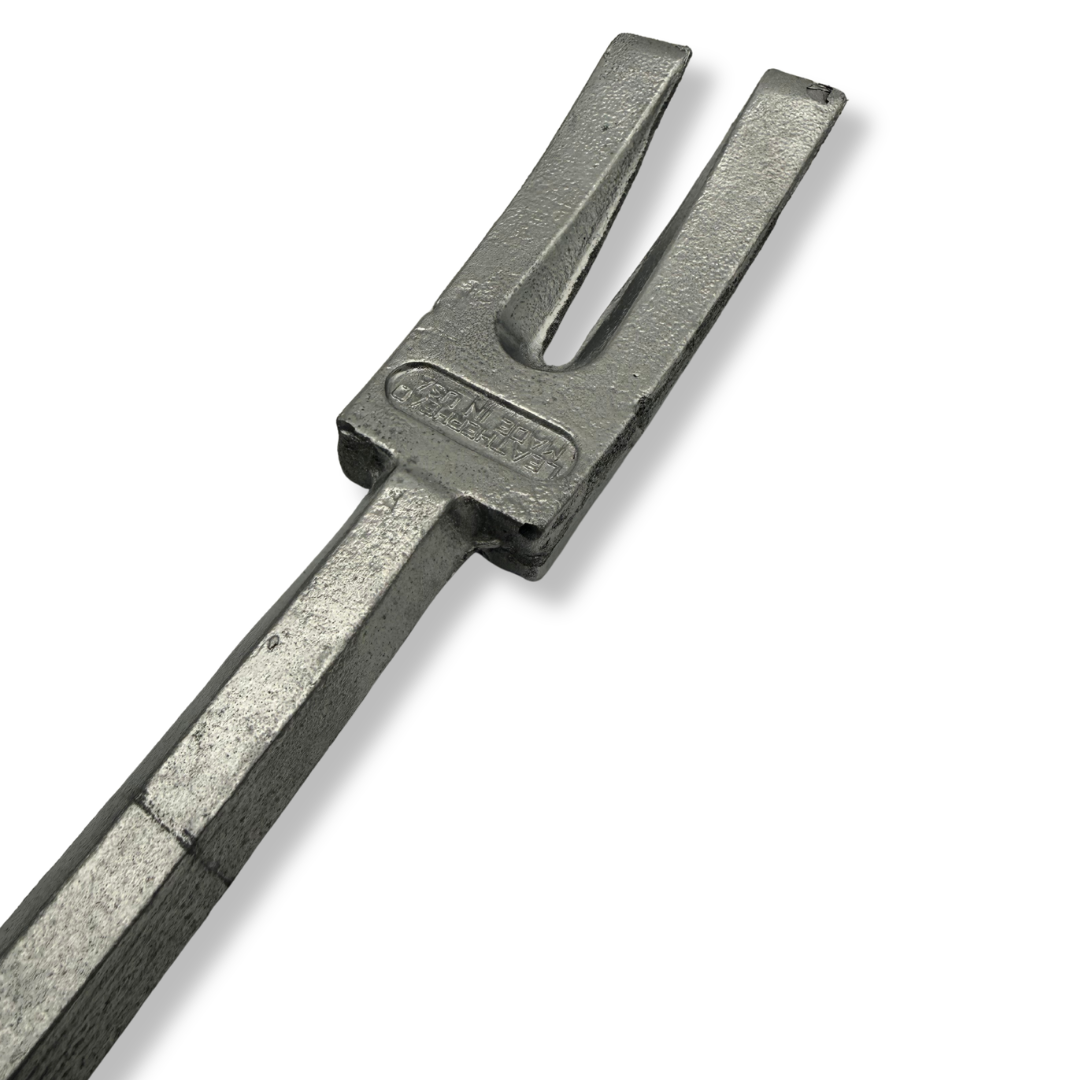 A heavy-duty cast iron fork or divider tool with a textured gray finish, featuring a stamped 'TAYLOR' brand mark on the head, shown on a plain white background.