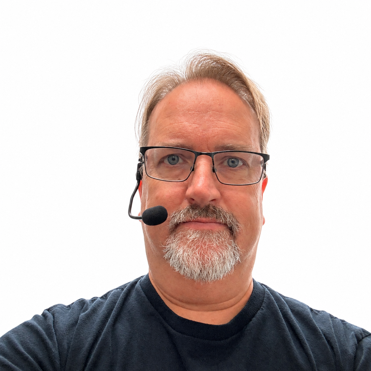Person wearing the black headset microphone prop with its foam-covered boom positioned beside their mouth.