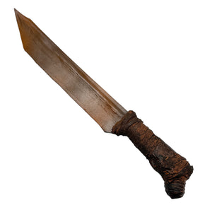 A prop machete-style knife with a weathered brown blade and a textured, dark brown wrapped handle, isolated on a white background.
