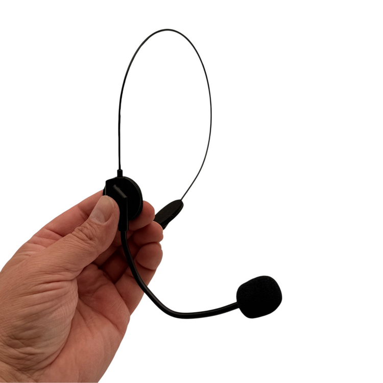Hand holding the black headset microphone prop, showing the slim headband and foam-covered boom.