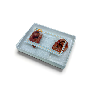 Two ears in a clear plastic container on a white background