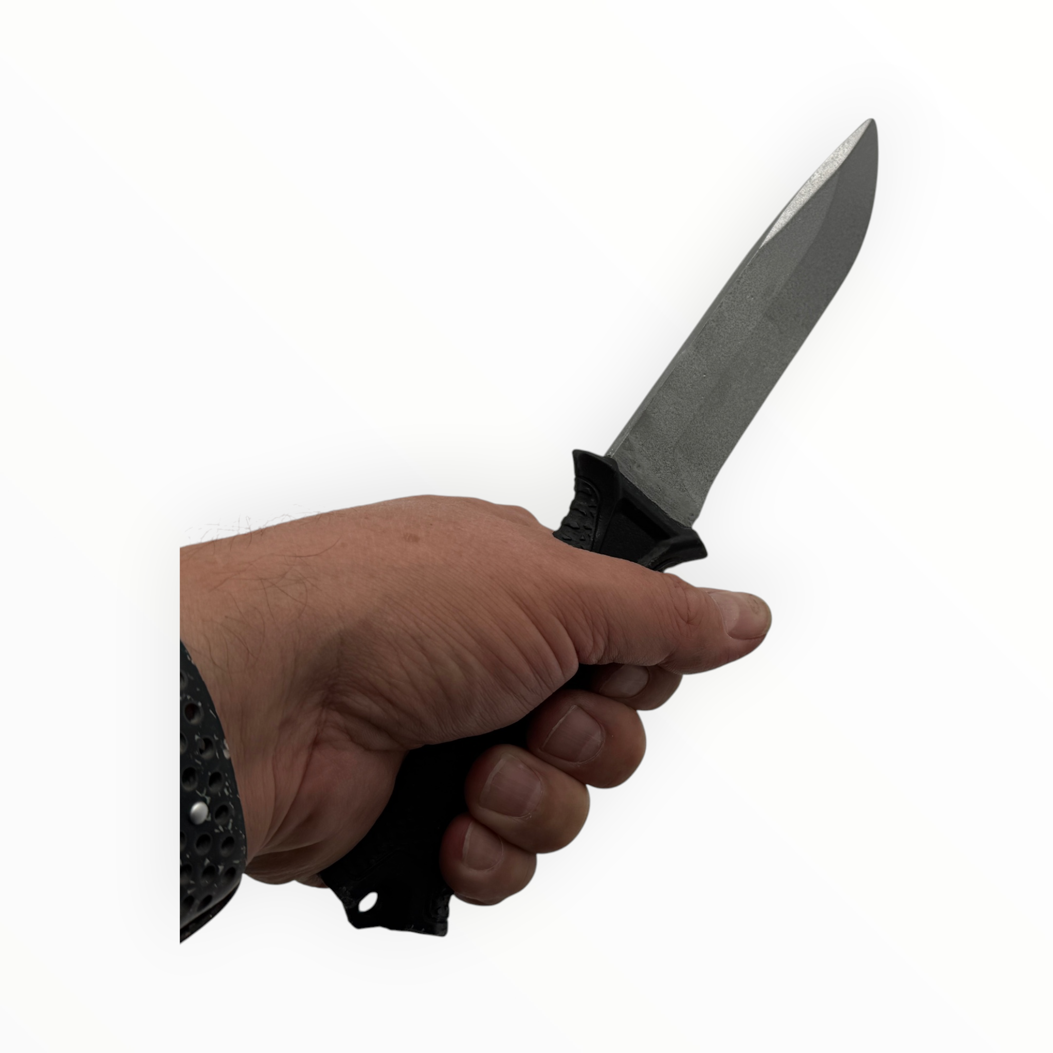 Hand holding a knife with a black handle on a white background