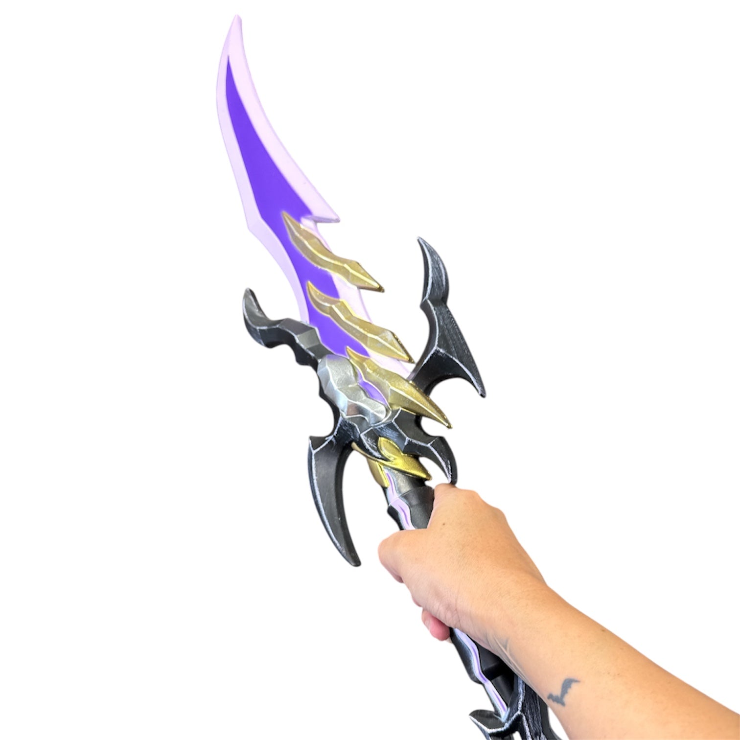 Hand holding a Foam Solo Leveling Antares Fangs Dagger Prop with a translucent purple blade and gold accents, highlighting fantasy-style craftsmanship.
