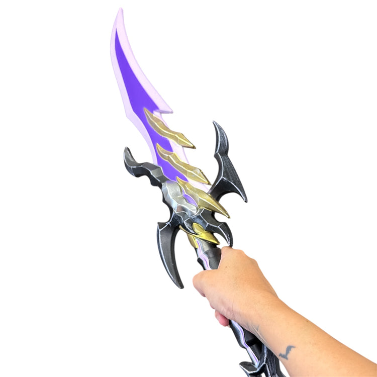 Hand holding a Foam Solo Leveling Antares Fangs Dagger Prop with a translucent purple blade and gold accents, highlighting fantasy-style craftsmanship.