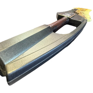 Foam Giant Monster Jawblade Sword Prop with a flame-shaped yellow tip, black blade, and brown-wrapped handle, measuring approximately 47” x 12” x 4”.