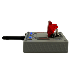 A handheld electronic device with a gray plastic housing, a black antenna, blue buttons, and a red transparent cover on top, shown against a plain white background.