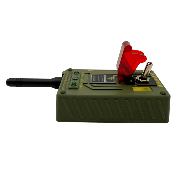 A green military-style electronic device with a black antenna, green buttons, a red translucent hinged cover, and a silver switch, shown on a plain white background.